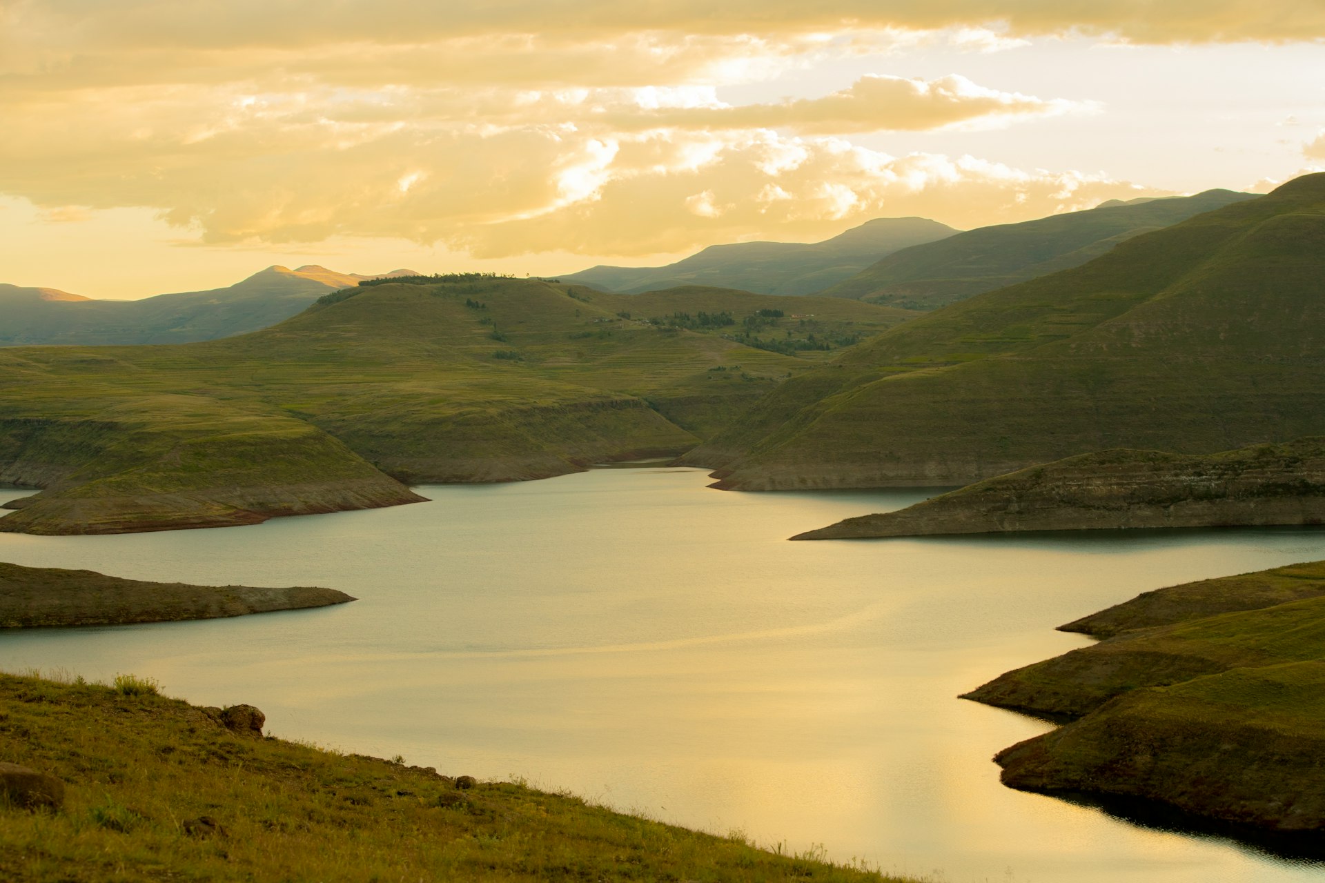 Lesotho mountains and water under dramatic white clouds