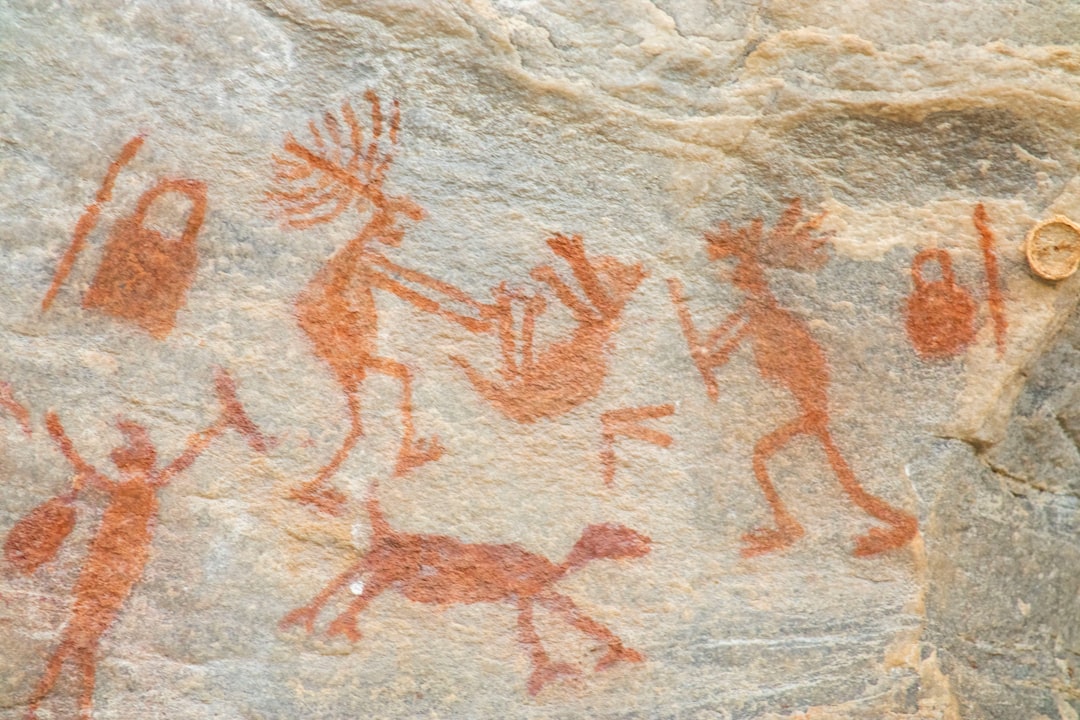 Ancient rock art pigments on a stone face — representative of San heritage at Tsodilo